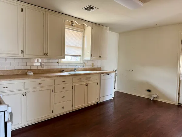 a view of a kitchen with sink and cabinets