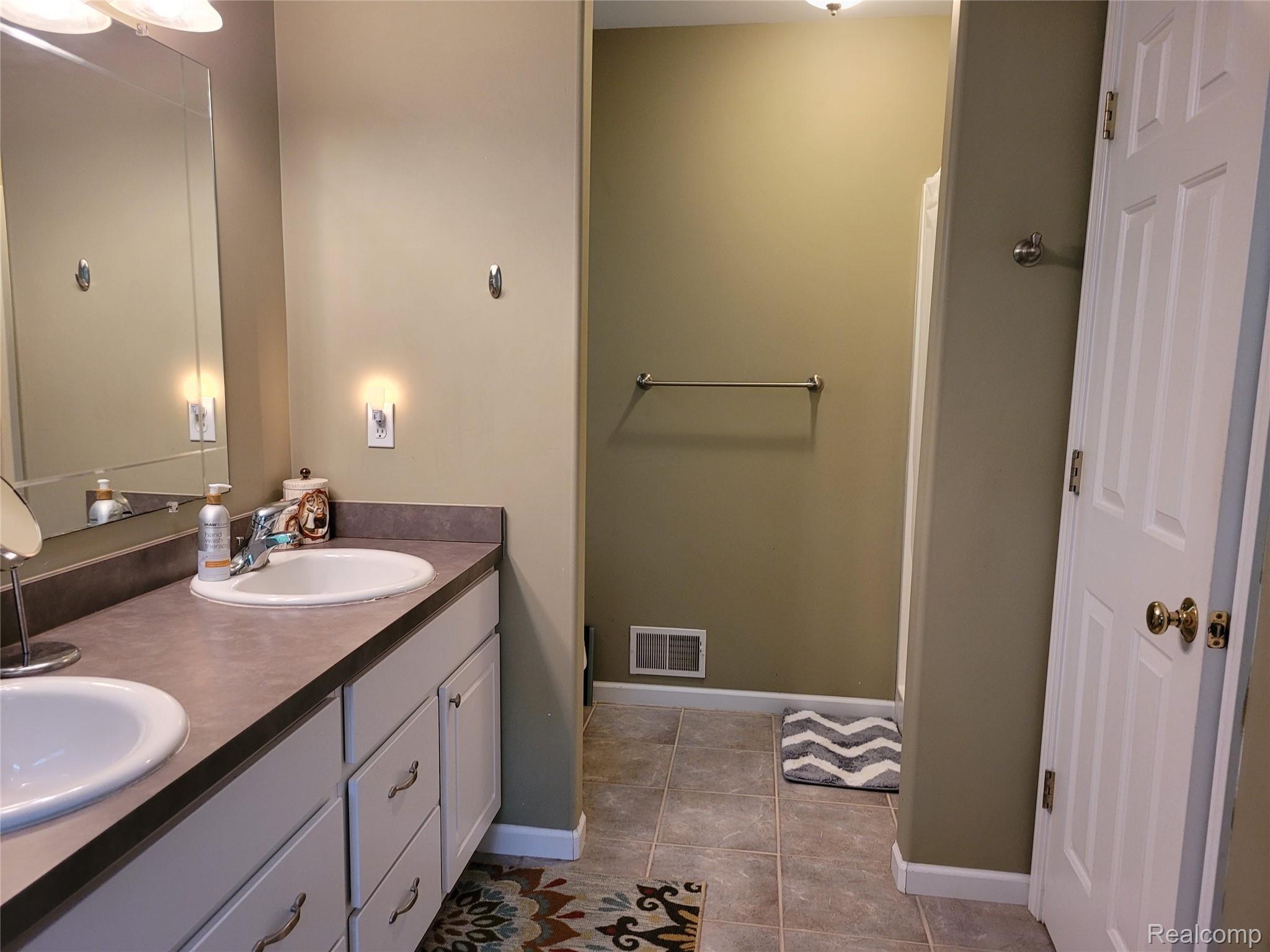 9235 North Fowlerville Road Fowlerville, MI 48836 - Photo 16 of 31 9235 Masre Bath 1.jpg