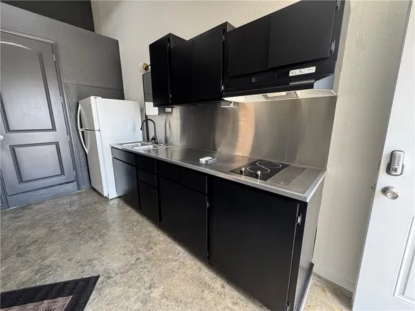 a kitchen with stainless steel appliances a refrigerator and a stove