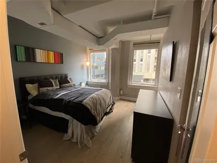 a bedroom with a bed and a large window