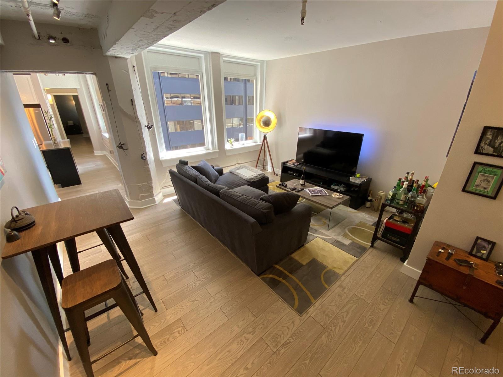 444 17th Street, Unit 508 Denver, CO 80202 - Photo 6 of 28 a living room with furniture and a flat screen tv