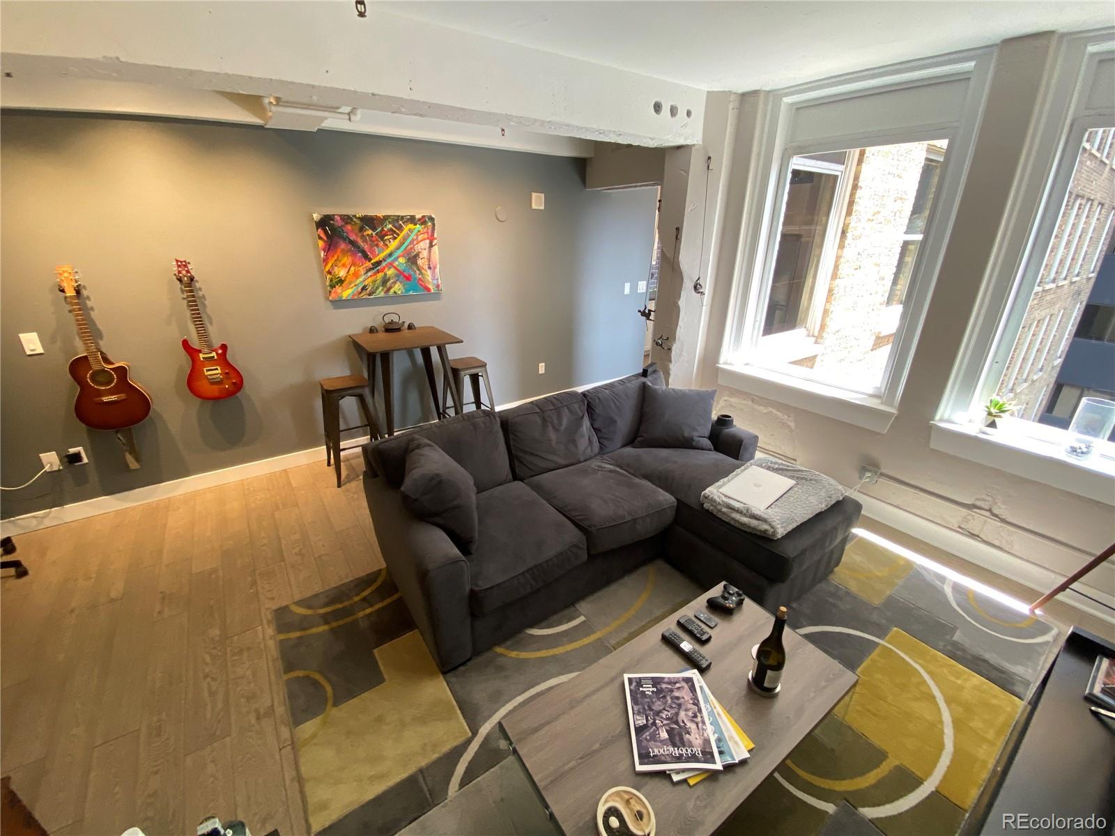 444 17th Street, Unit 508 Denver, CO 80202 - Photo 8 of 28 a living room with furniture and a flat screen tv