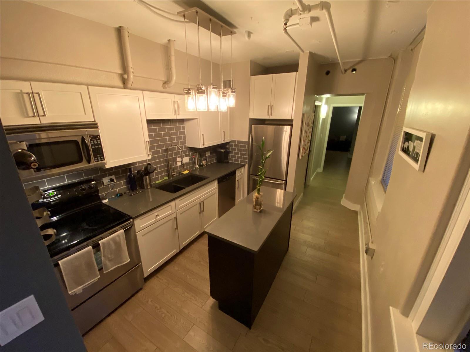 444 17th Street, Unit 508 Denver, CO 80202 - Photo 10 of 28 a kitchen with stainless steel appliances a refrigerator a stove a sink dishwasher and wooden cabinets