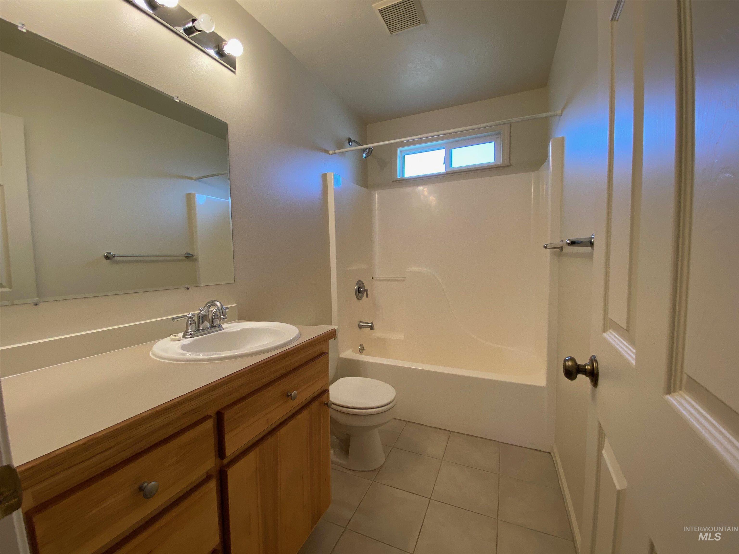 109 Adams Street Horseshoe Bend, ID 83629 - Photo 6 of 13 Full bathroom featuring vanity, bathtub / shower combination, and light tile patterned floors