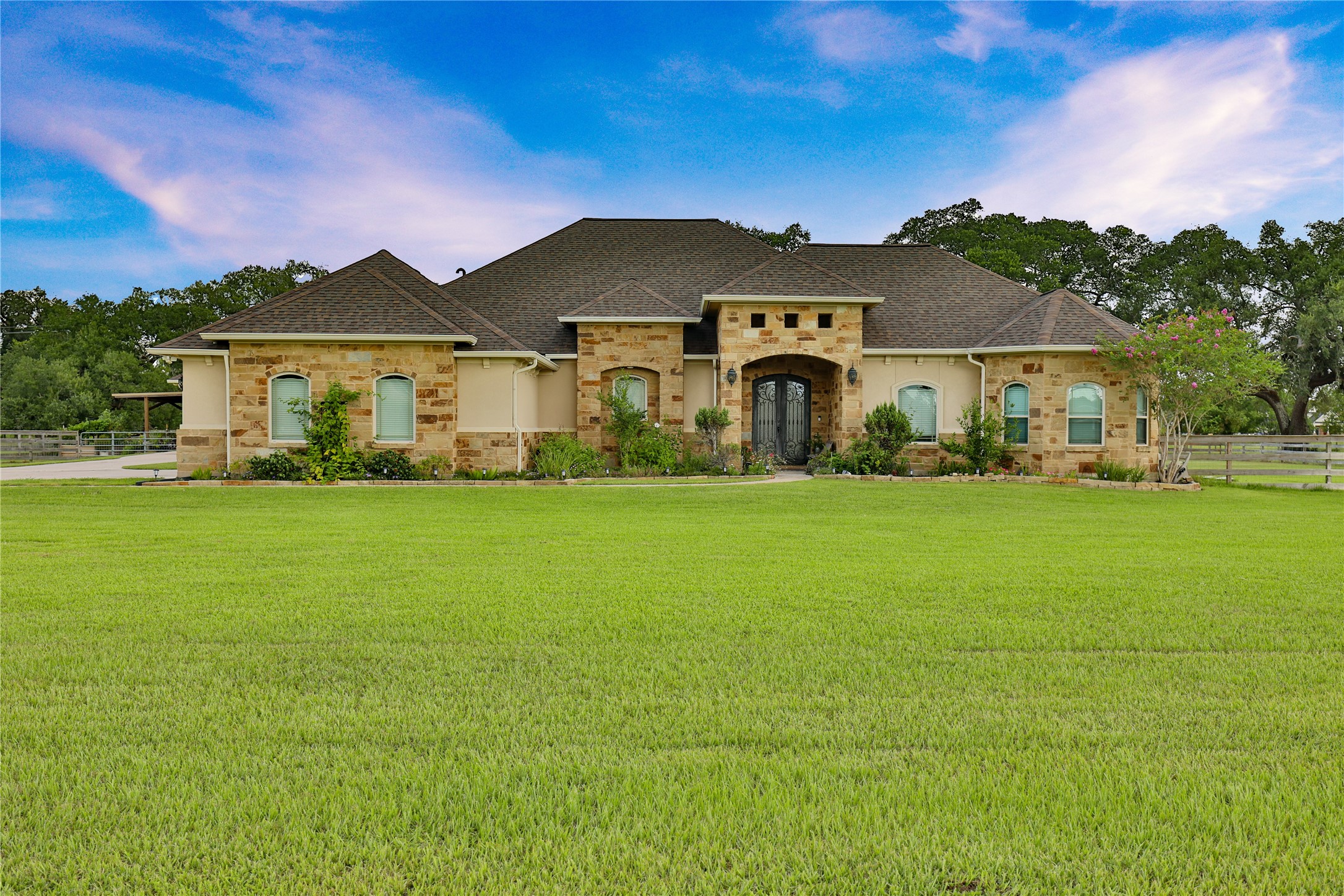 a front view of house with yard and green space