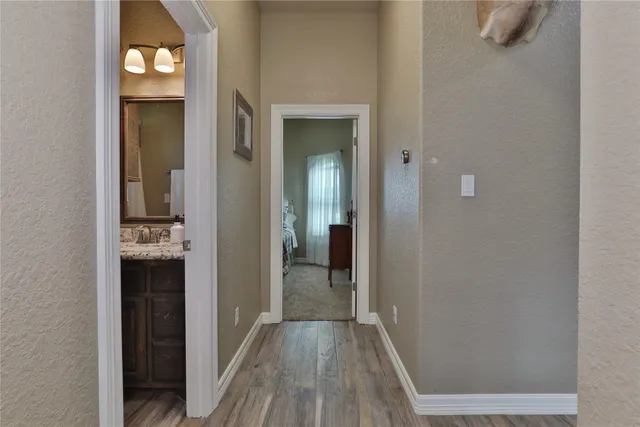 a view of a hallway with wooden floor and closet
