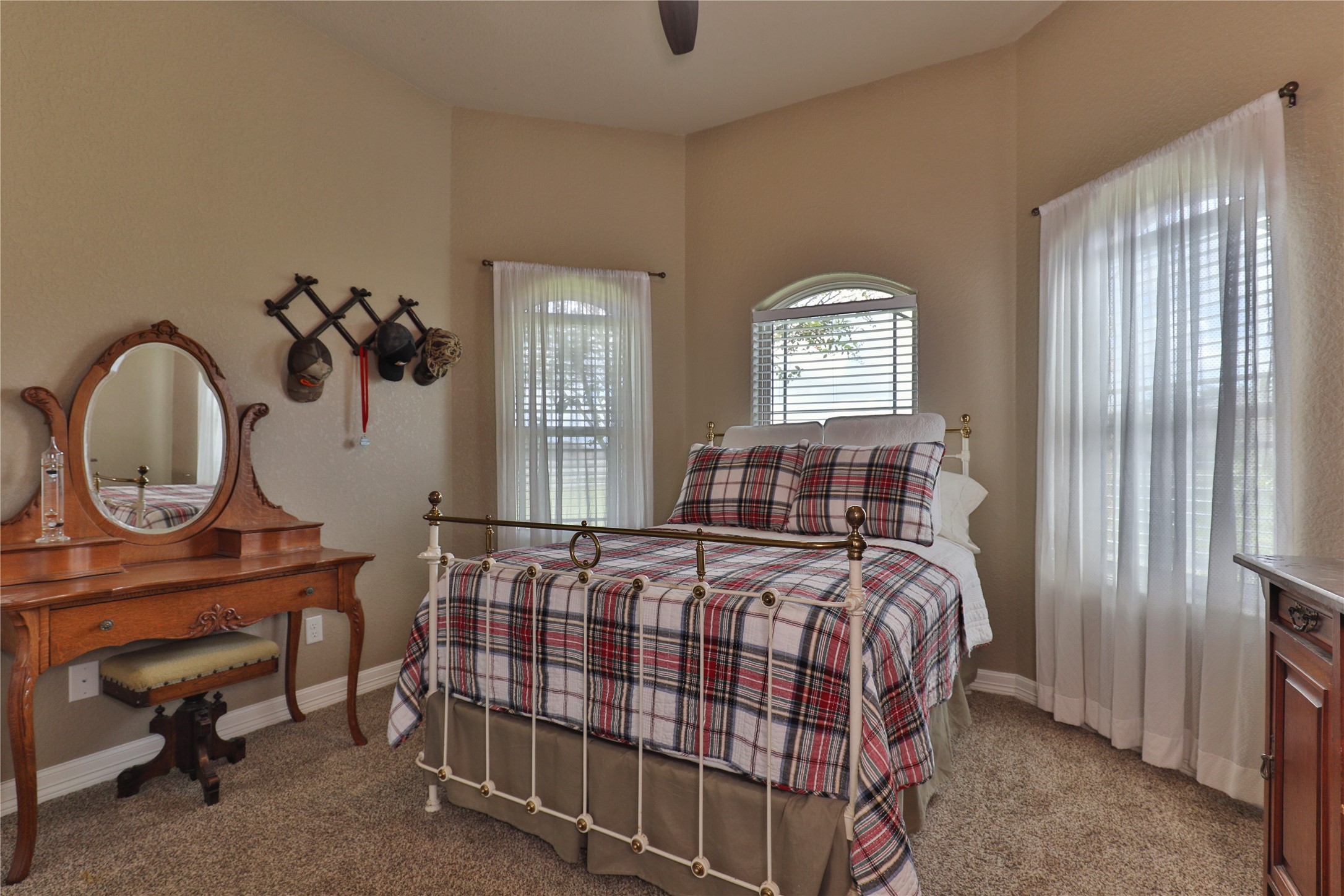 814 Comanche Trail Drive Rosharon, TX 77583 - Photo 33 of 50 a bedroom with a bed a window and a chandelier