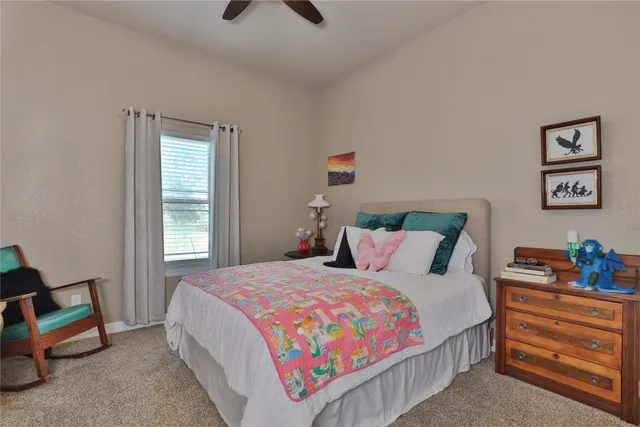 a bedroom with bed and a window