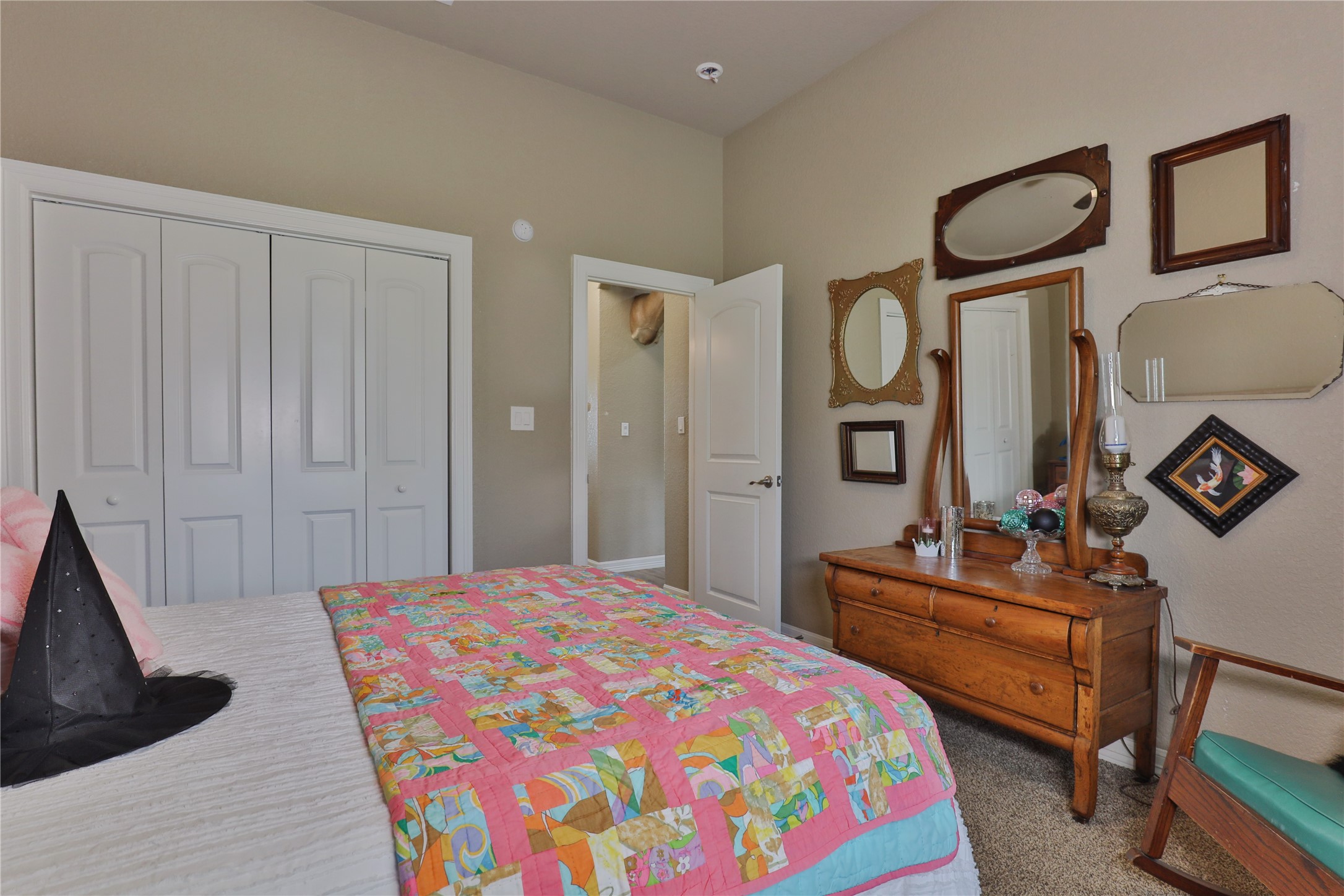 814 Comanche Trail Drive Rosharon, TX 77583 - Photo 37 of 50 a bedroom with a bed a dresser and mirror