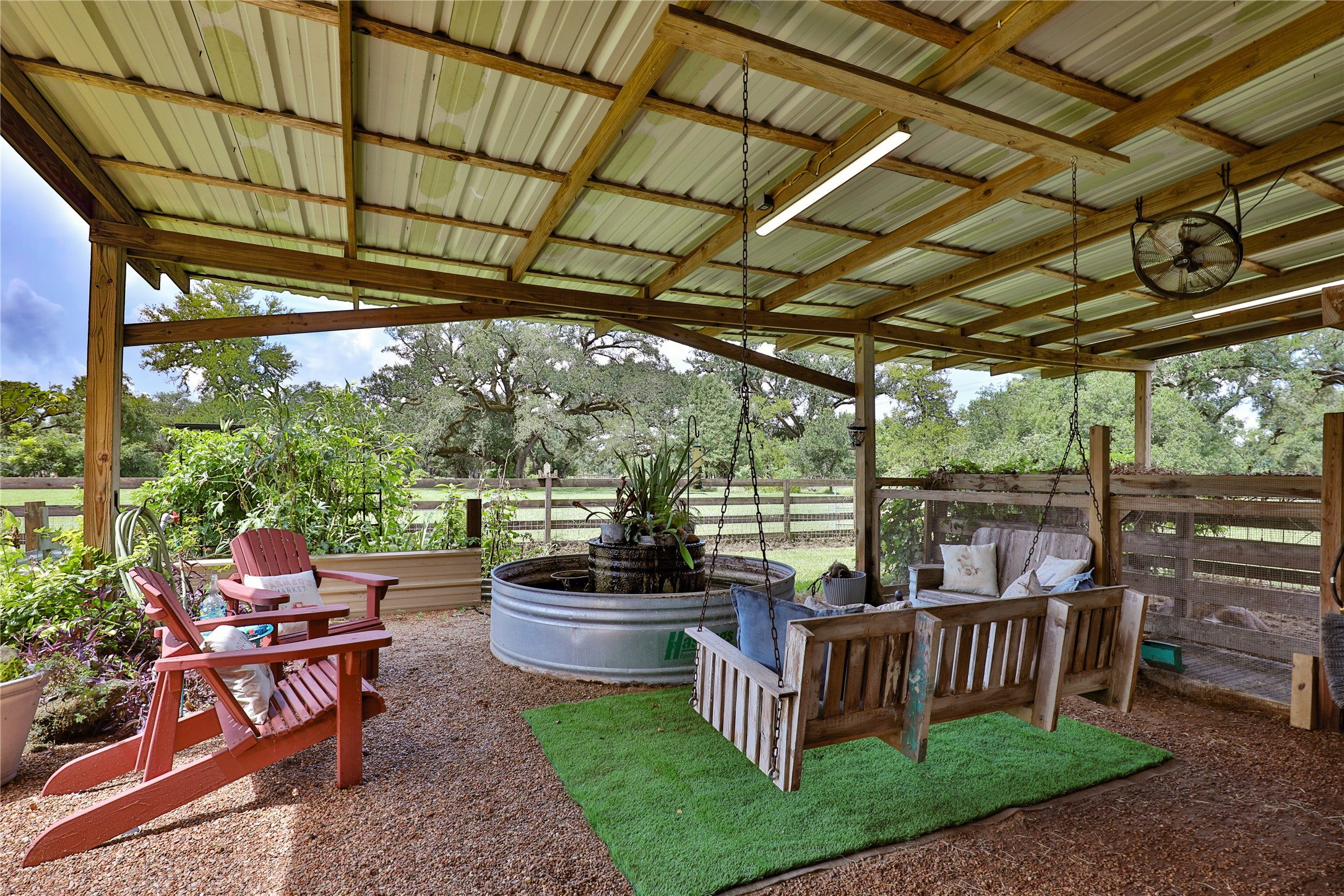 814 Comanche Trail Drive Rosharon, TX 77583 - Photo 45 of 50 a view of a patio with table and chairs potted plants with wooden floor and fence