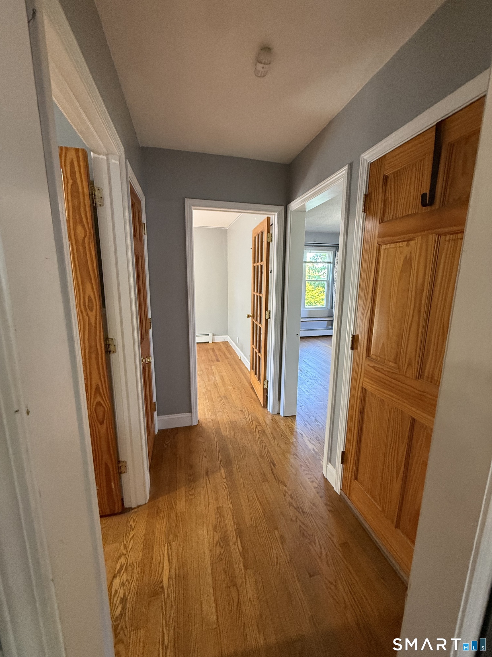 808 East Main Street Torrington, CT 06790 - Photo 21 of 40 a view of a hallway with wooden floor and curtain