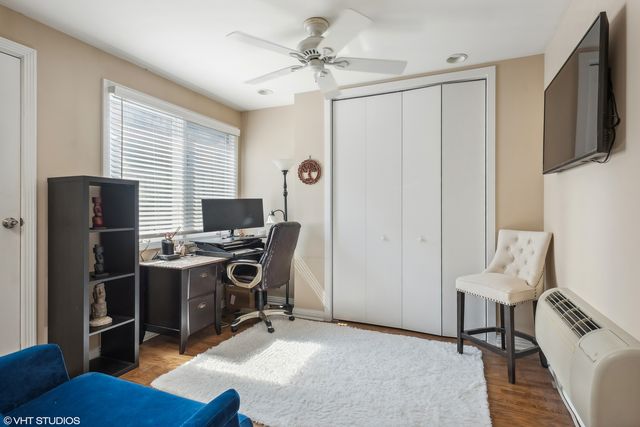 a view of a workspace with furniture and a window