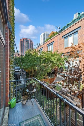 a balcony view with two chairs and a table