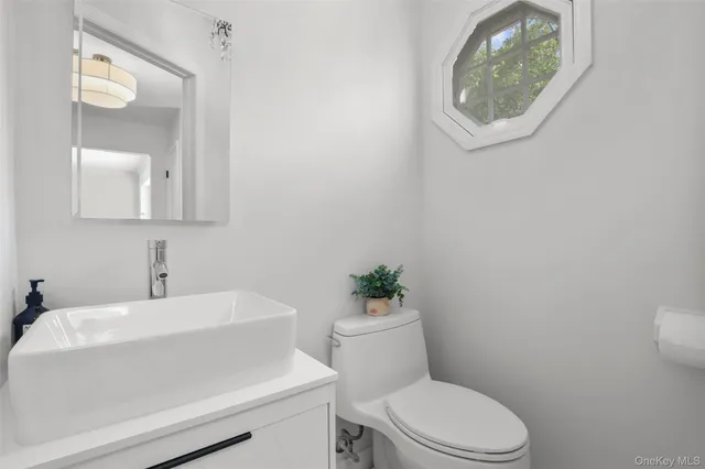 a white toilet sitting next to a bathroom sink