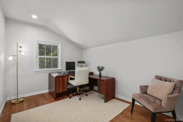 a view of a workspace with a window and lounge chair