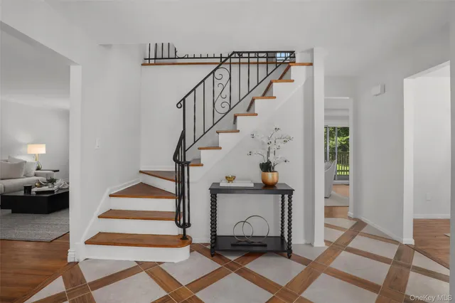 a view of entryway and hall with wooden floor