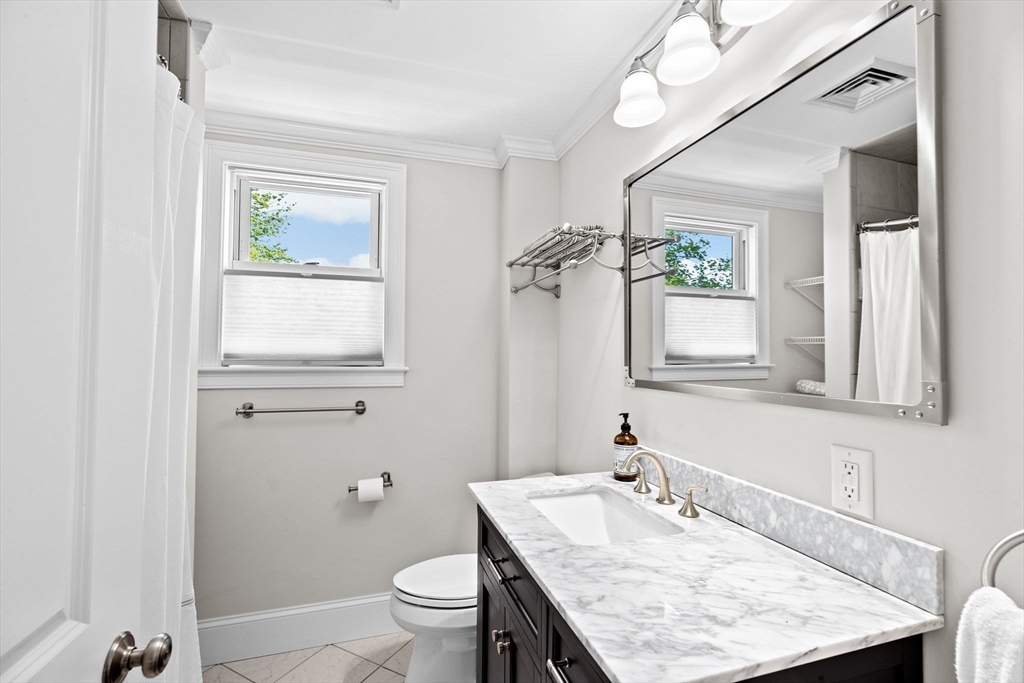 19 Damon Road Scituate, MA 02066 - Photo 17 of 29 a bathroom with a granite countertop sink a toilet and a mirror