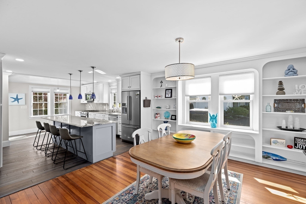 19 Damon Road Scituate, MA 02066 - Photo 7 of 29 a dining room with stainless steel appliances kitchen island granite countertop a dining table chairs and a living room view