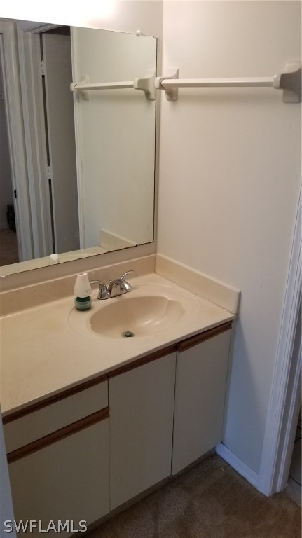 5665 Whitaker Road, Unit A101 Naples, FL 34112 - Photo 13 of 17 a bathroom with a sink and a mirror