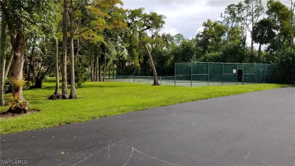 5665 Whitaker Road, Unit A101 Naples, FL 34112 - Photo 2 of 17 a view of a park with a tree