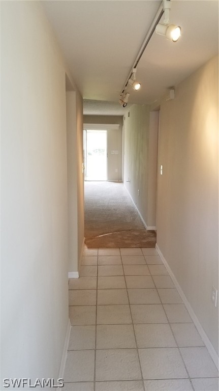 5665 Whitaker Road, Unit A101 Naples, FL 34112 - Photo 3 of 17 a view of hallway with a window and a fireplace