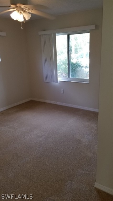 5665 Whitaker Road, Unit A101 Naples, FL 34112 - Photo 9 of 17 an empty room with a window