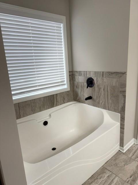 116 Teramont Court Dallas, GA 30132 - Photo 11 of 19 a bathroom with a bathtub and a window