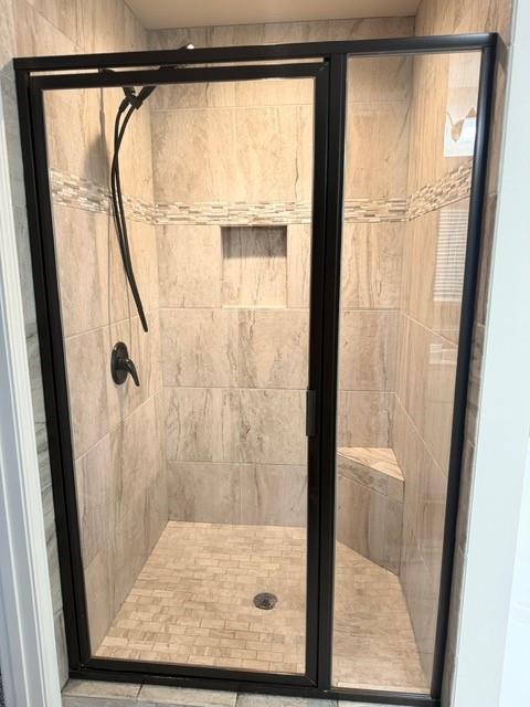 116 Teramont Court Dallas, GA 30132 - Photo 10 of 19 a bathroom with a glass shower door and a window