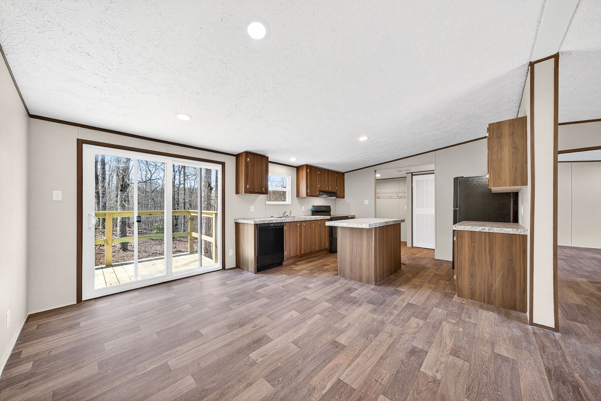 428 Maple Branch Road Sparta, TN 38583 - Photo 12 of 28 a large kitchen with a large counter top a sink stainless steel appliances and cabinets