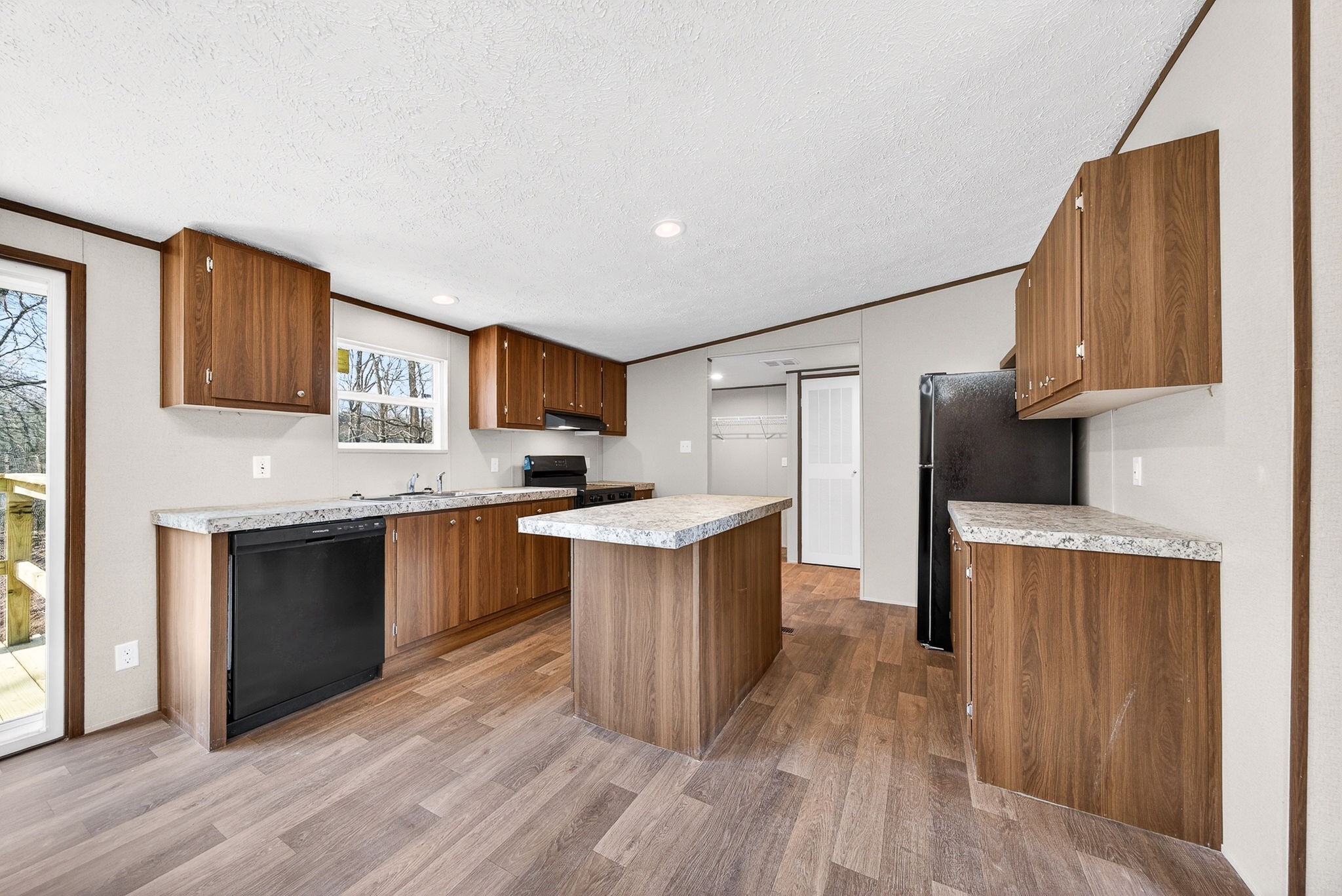 428 Maple Branch Road Sparta, TN 38583 - Photo 13 of 28 a kitchen with a sink cabinets stainless steel appliances and a window