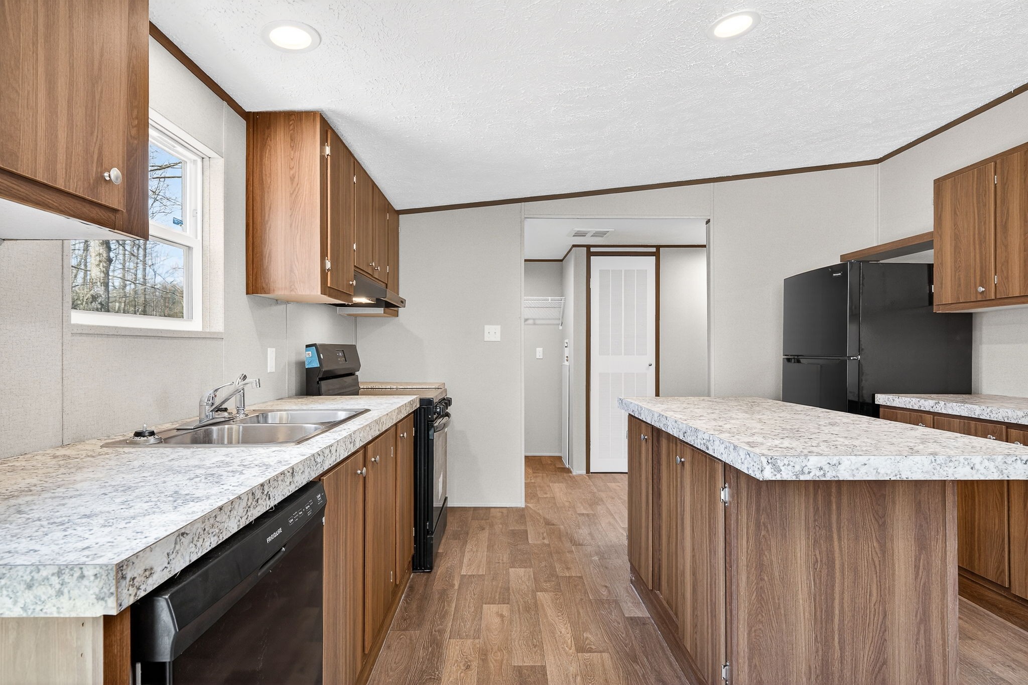 428 Maple Branch Road Sparta, TN 38583 - Photo 14 of 28 a kitchen with a granite countertop sink refrigerator and cabinets