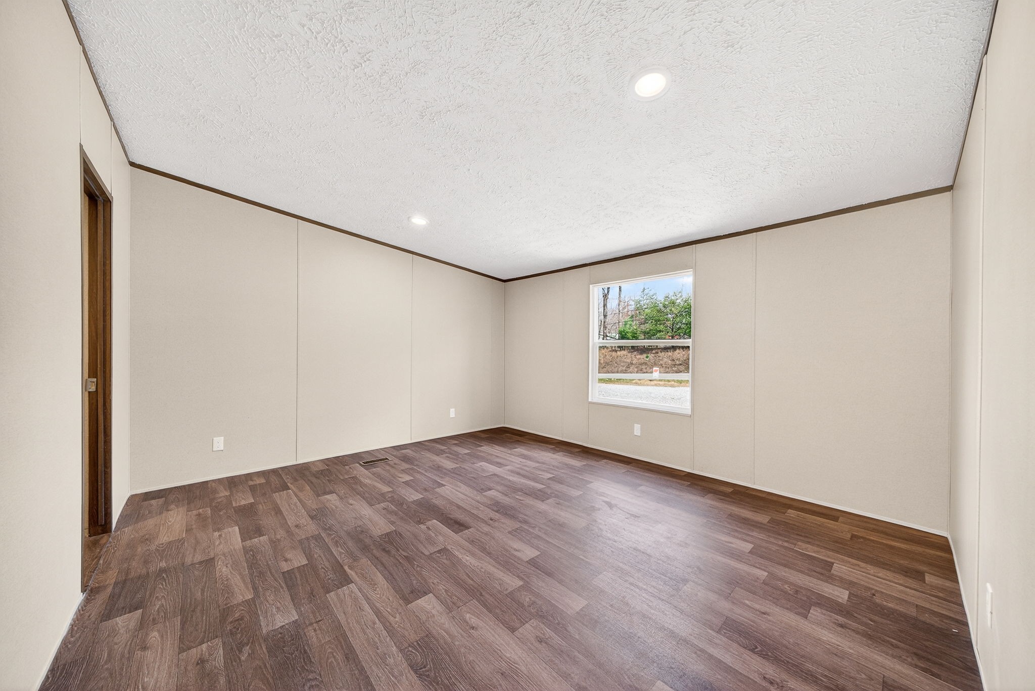 428 Maple Branch Road Sparta, TN 38583 - Photo 18 of 28 an empty room with wooden floor and windows