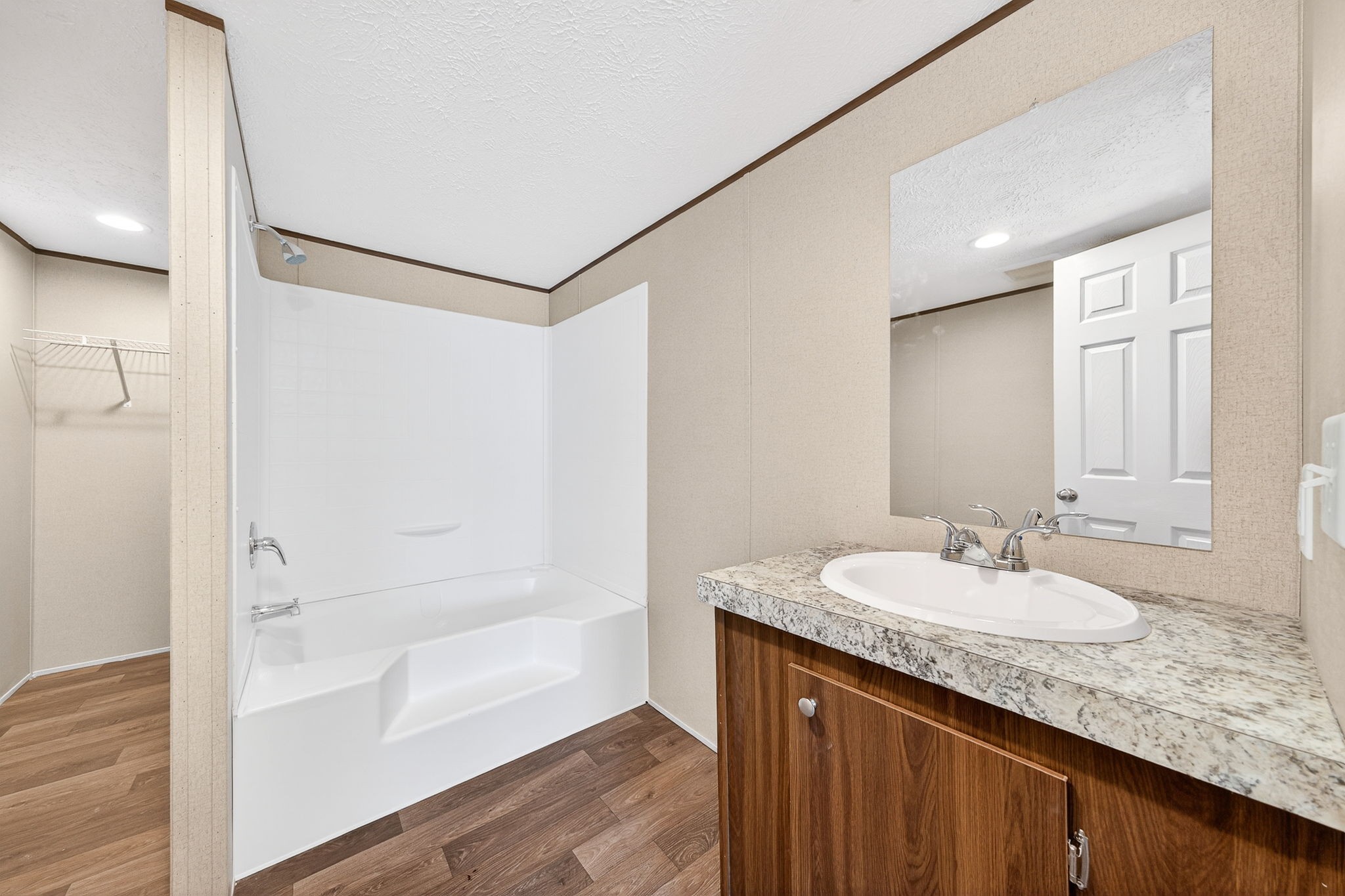 428 Maple Branch Road Sparta, TN 38583 - Photo 20 of 28 a bathroom with a granite countertop sink a mirror and a bathtub