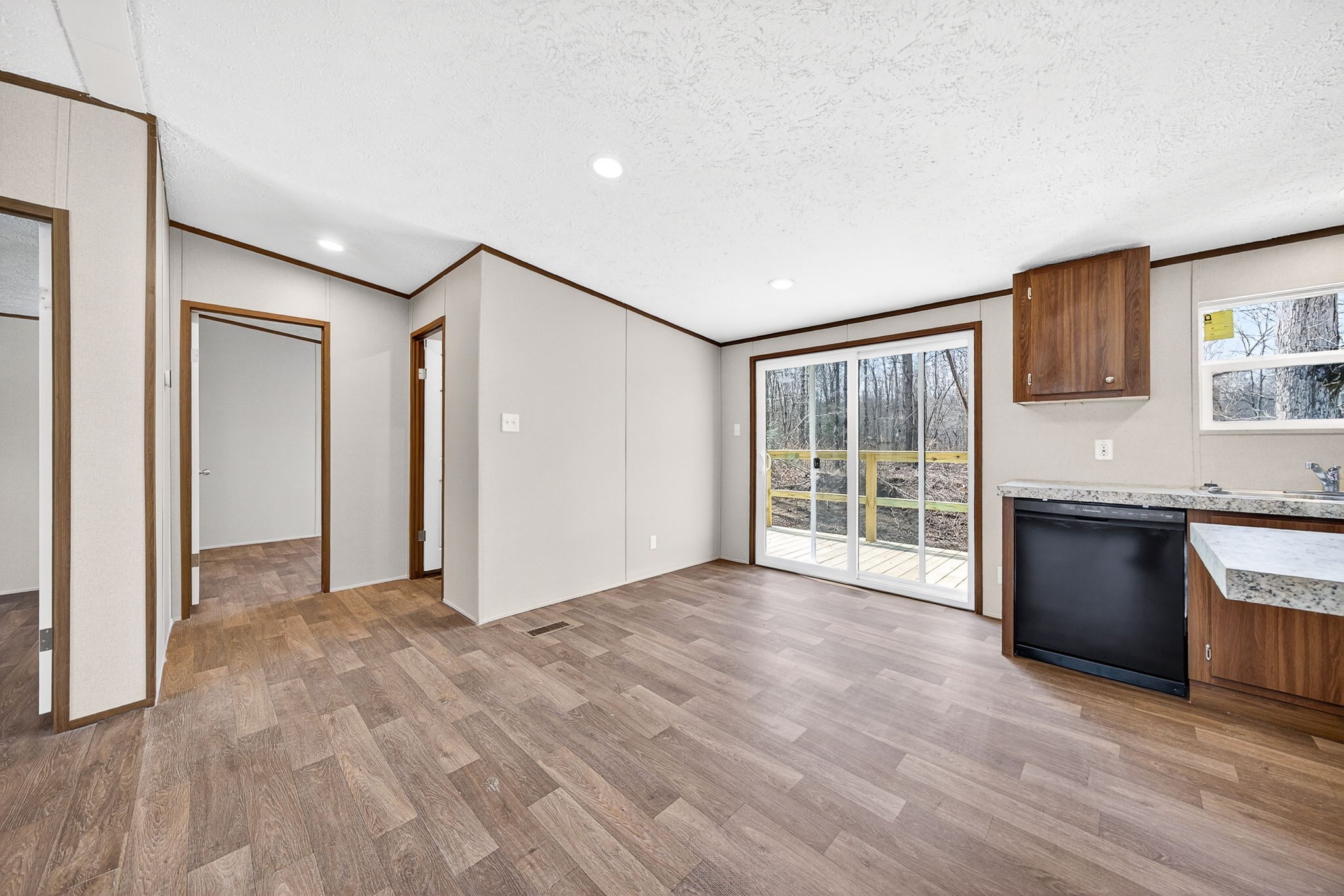 428 Maple Branch Road Sparta, TN 38583 - Photo 22 of 28 a view of a big room with wooden floor and a kitchen