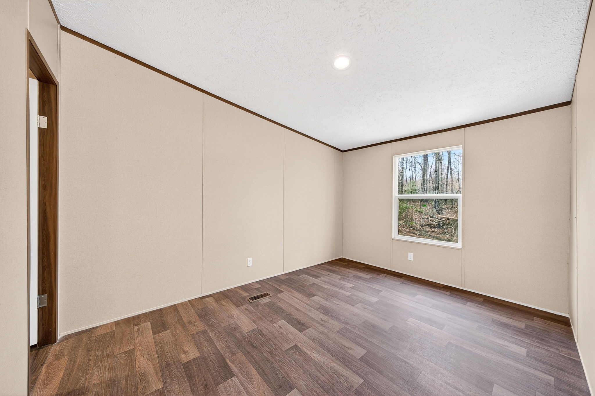 428 Maple Branch Road Sparta, TN 38583 - Photo 23 of 28 an empty room with wooden floor and windows