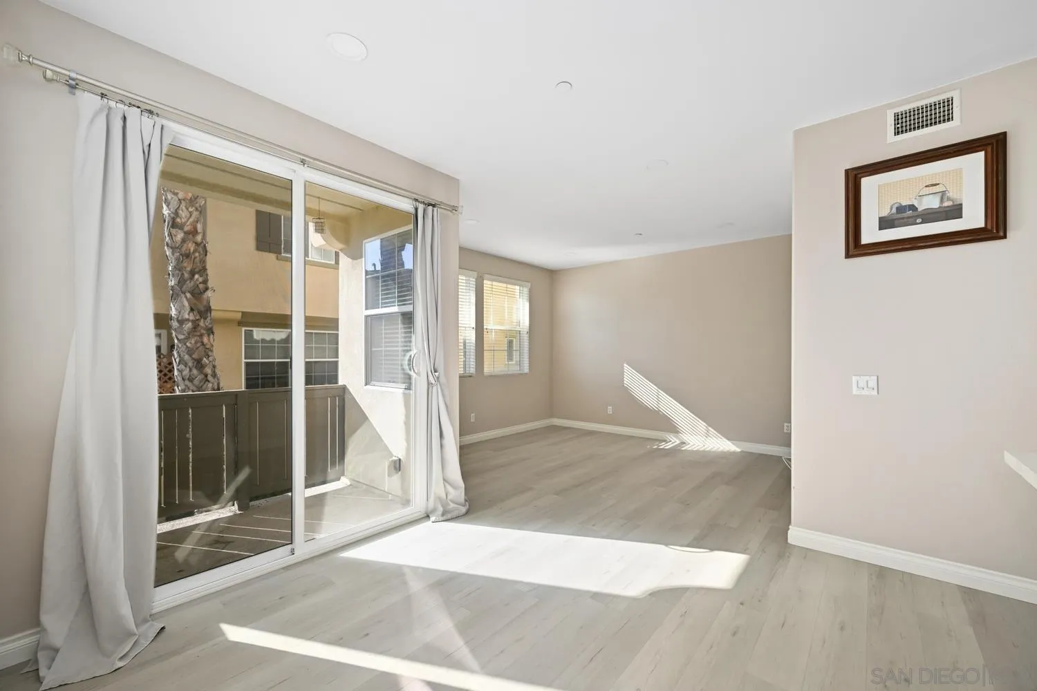 5074 Cascade Way, Unit 102 Oceanside, CA 92057 - Photo 12 of 30 a view of a hallway with wooden floor and windows