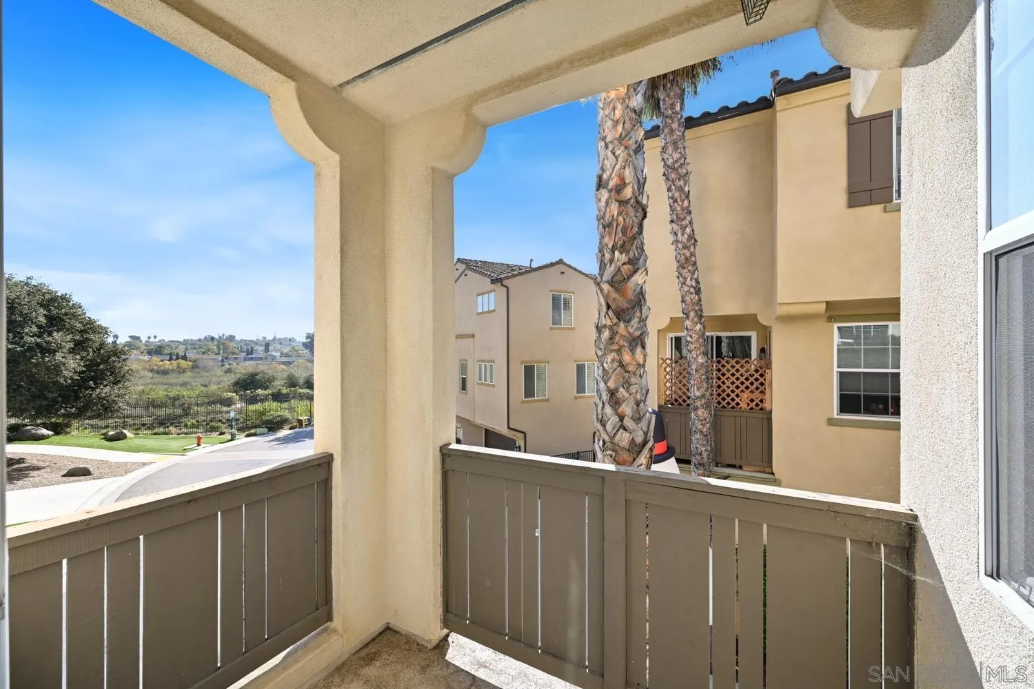 5074 Cascade Way, Unit 102 Oceanside, CA 92057 - Photo 13 of 30 a view of a balcony with wooden floor and fence