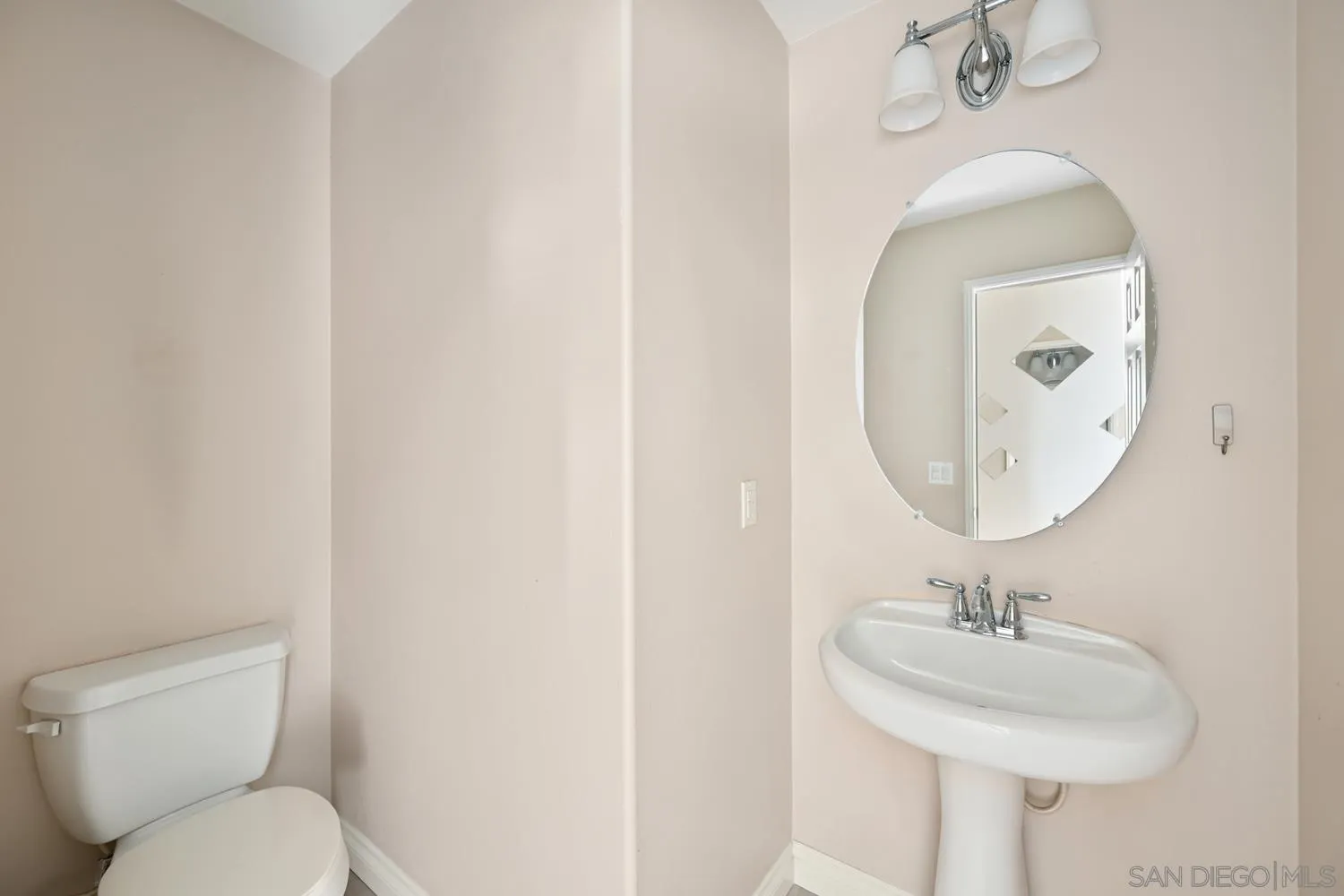 5074 Cascade Way, Unit 102 Oceanside, CA 92057 - Photo 14 of 30 a bathroom with a toilet sink and mirror