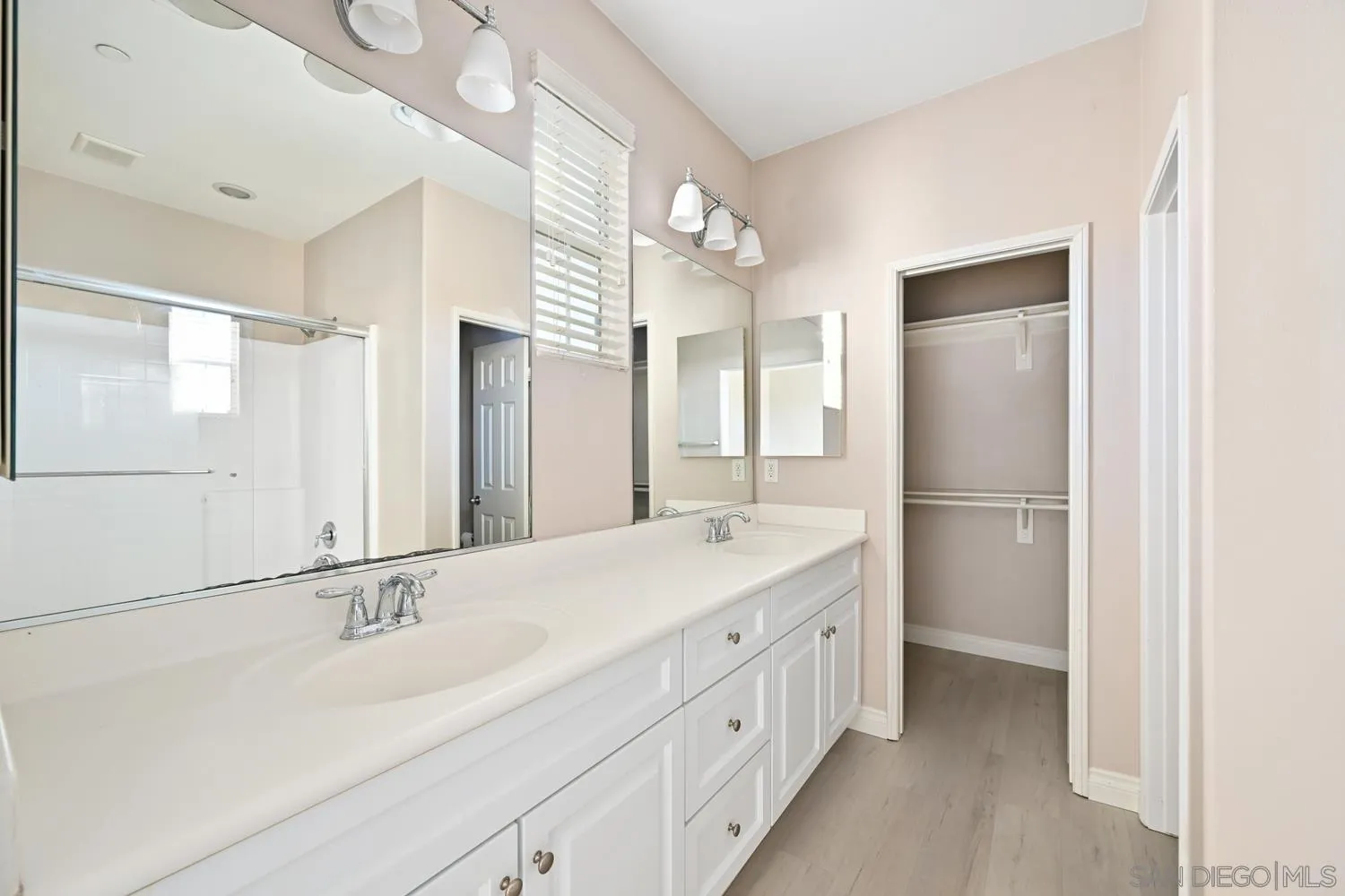 5074 Cascade Way, Unit 102 Oceanside, CA 92057 - Photo 18 of 30 a bathroom with a double vanity sink mirror and double