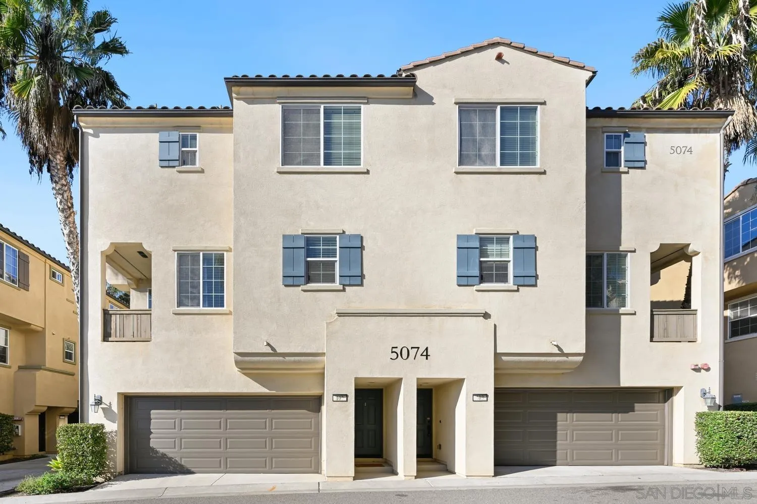 5074 Cascade Way, Unit 102 Oceanside, CA 92057 - Photo 2 of 30 a front view of a building with a yard