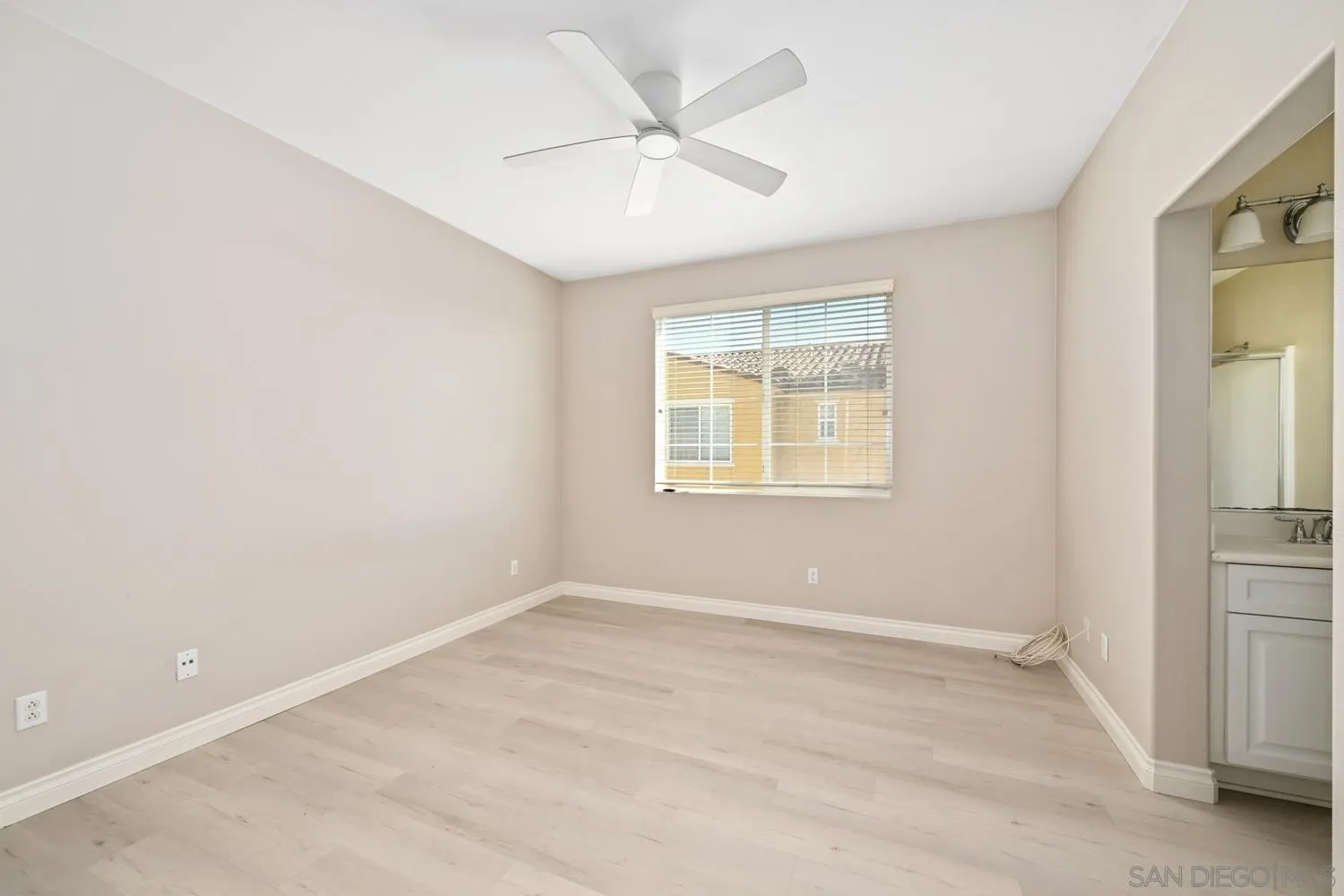 5074 Cascade Way, Unit 102 Oceanside, CA 92057 - Photo 21 of 30 an empty room with windows and fan