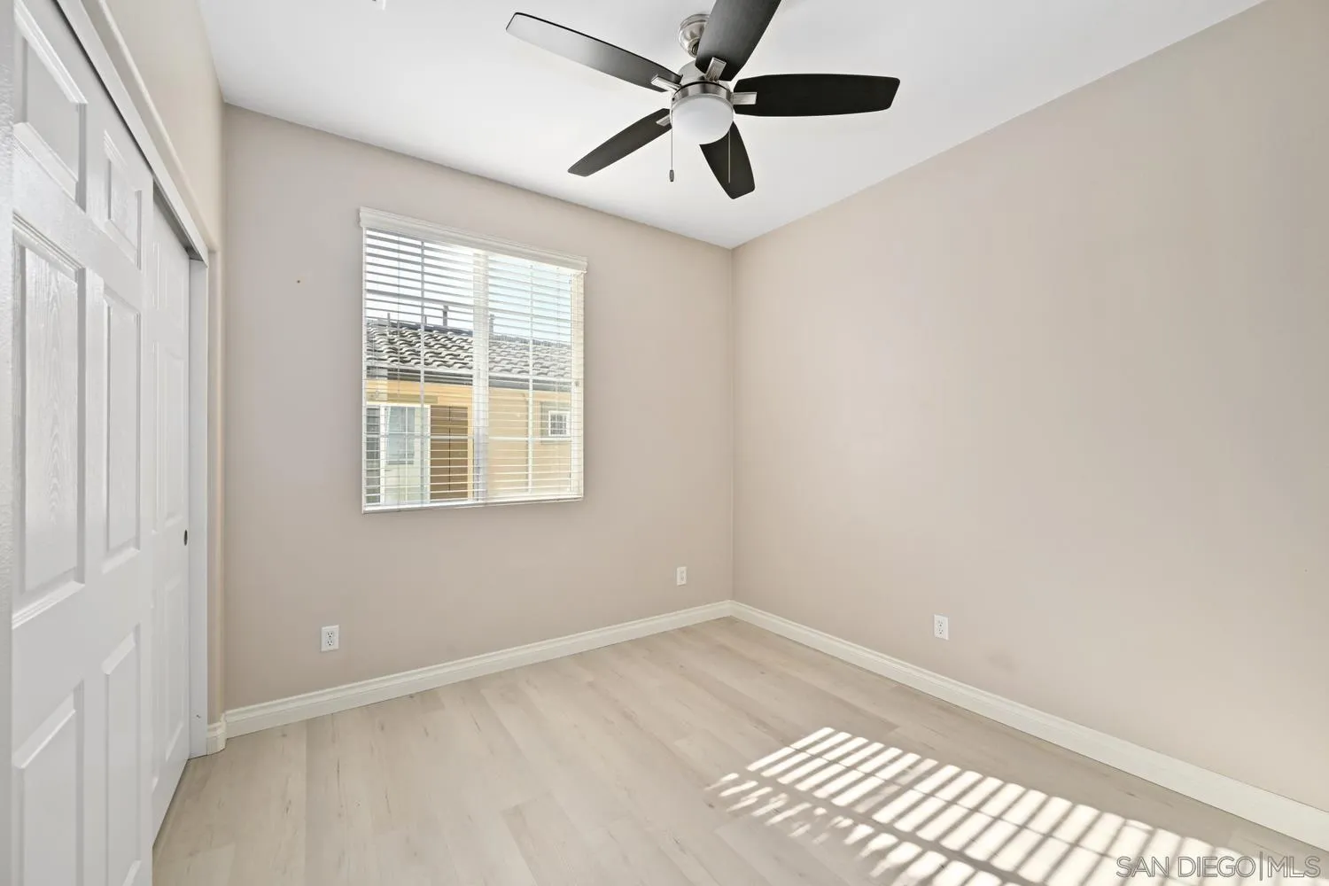 5074 Cascade Way, Unit 102 Oceanside, CA 92057 - Photo 22 of 30 an empty room with a window and a fan
