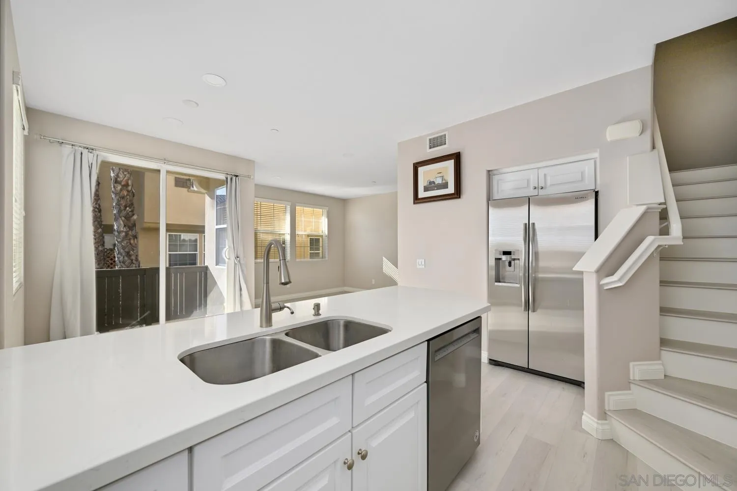 5074 Cascade Way, Unit 102 Oceanside, CA 92057 - Photo 10 of 30 a kitchen with stainless steel appliances granite countertop a sink and a refrigerator