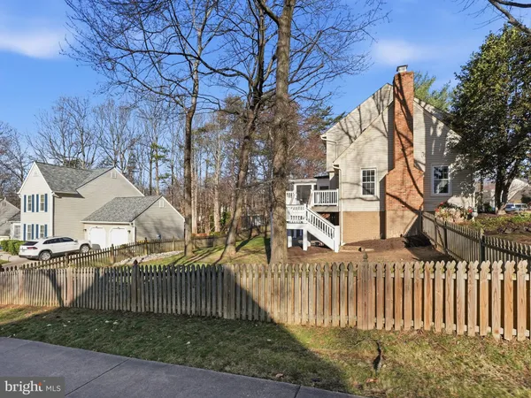 a living room with furniture stairs and a wooden floor