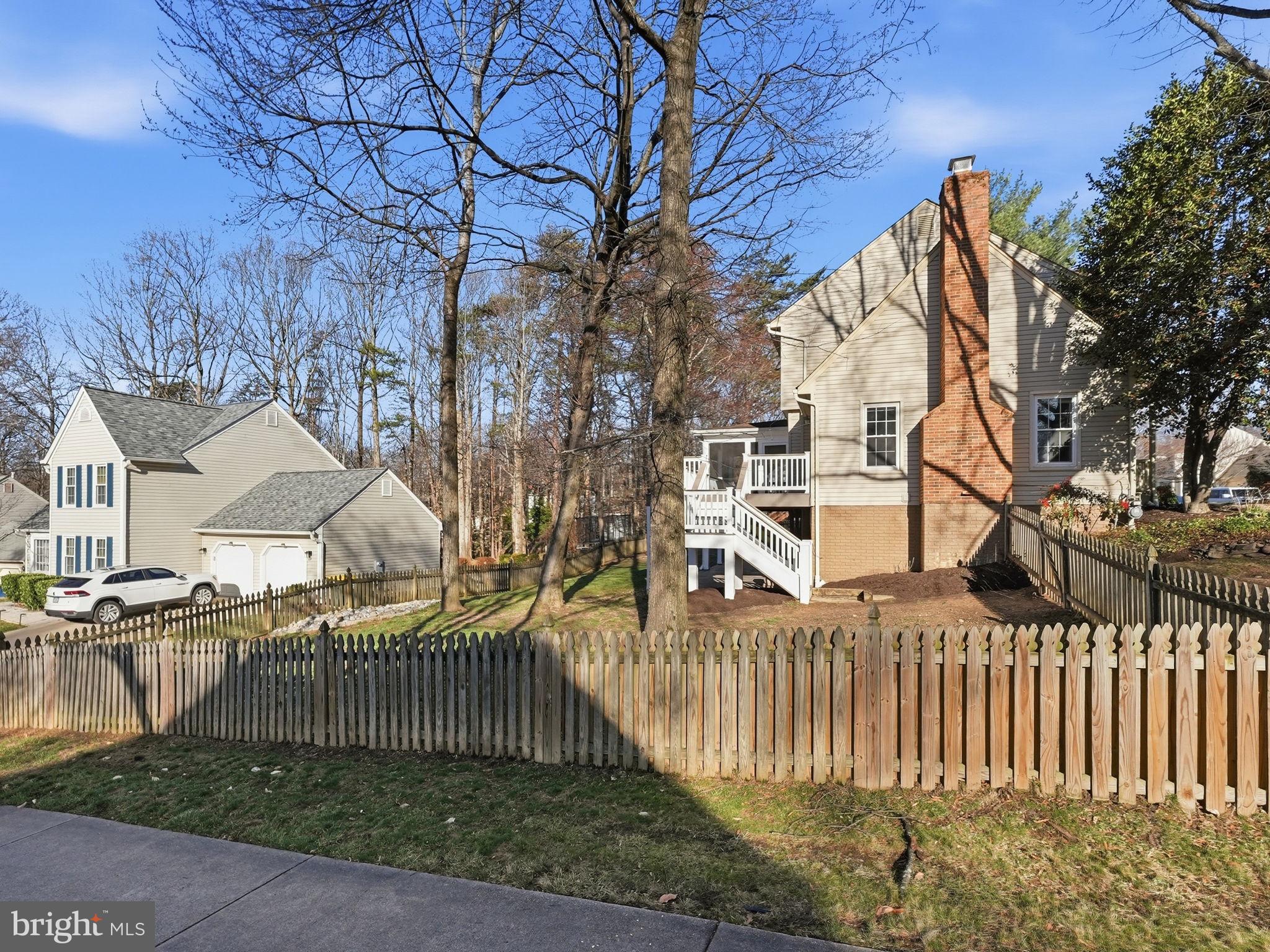 9115 Northedge Drive Springfield, VA 22153 - Photo 11 of 55 a view of a house with a small yard and wooden fence