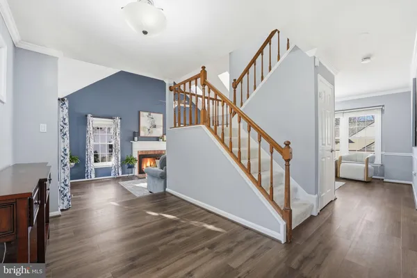 a living room with fireplace furniture and a wooden floor