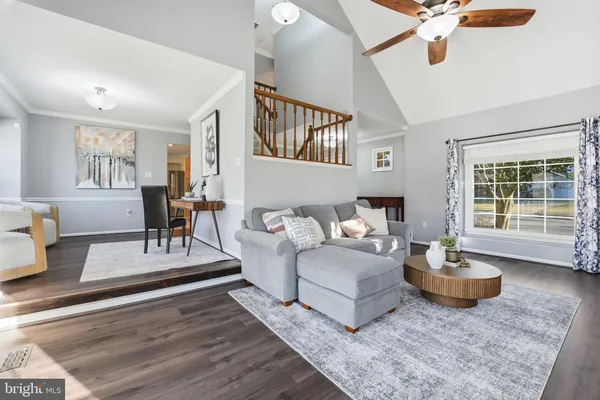 a view of a dining room with furniture and chandelier