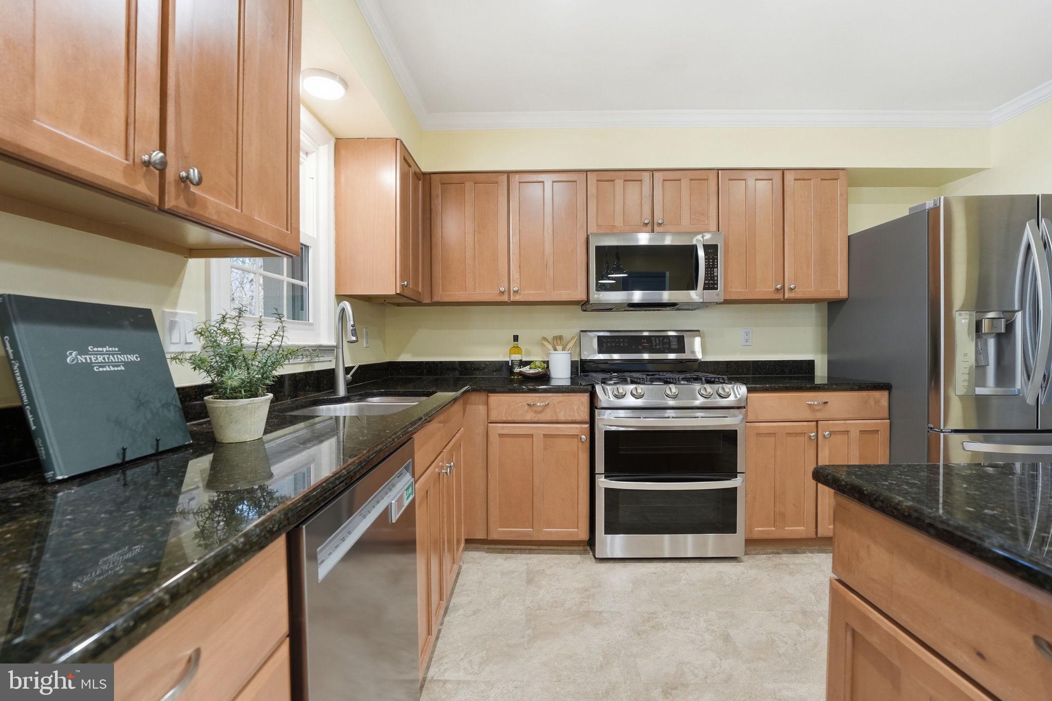 9115 Northedge Drive Springfield, VA 22153 - Photo 23 of 55 a kitchen with stainless steel appliances granite countertop a stove a sink and a microwave