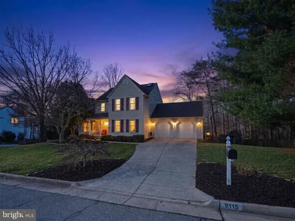 a view of a big house with a big yard and large trees