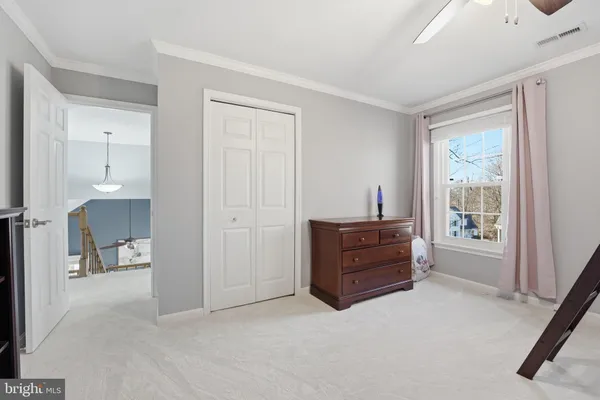 a spacious bedroom with a bed and a window